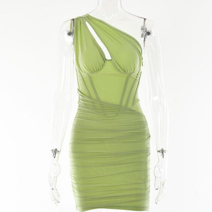 Lime green one-shoulder mini dress with ruched detailing on mannequin